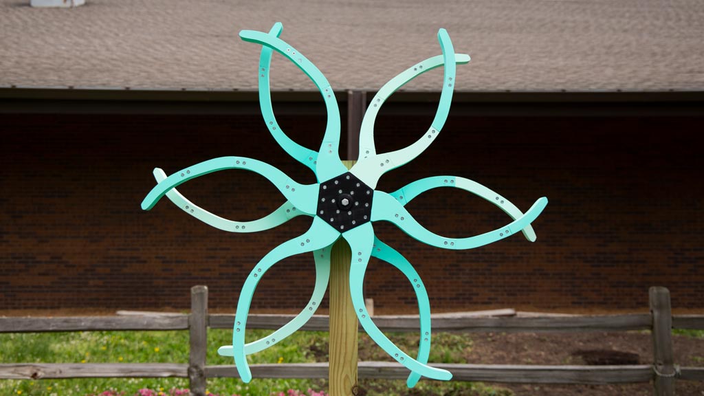 image of Judy Lee's kinetic sculpture of plastic pieces arranged like a flower pinwheel