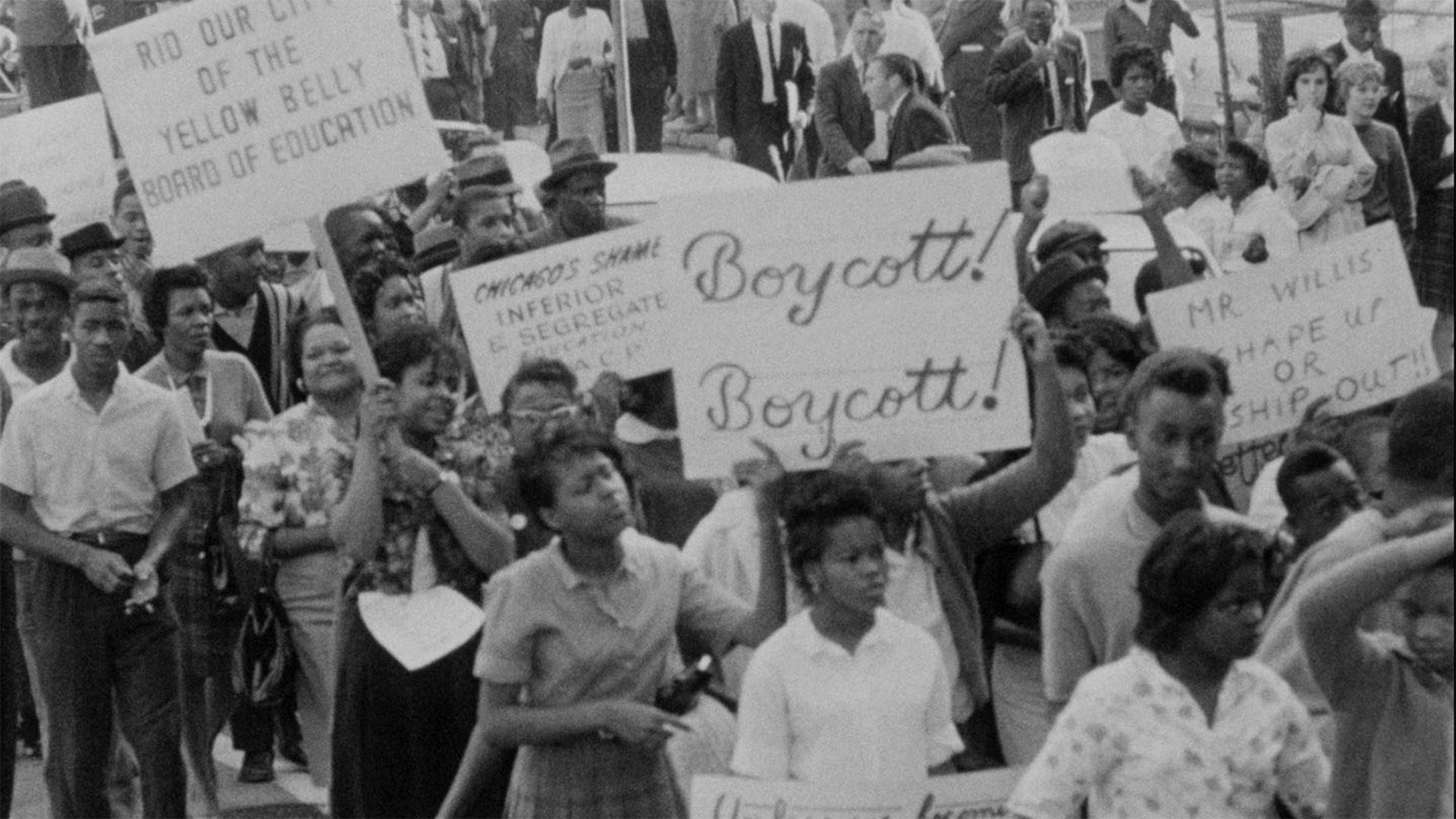Black protesters gather with signs reading "Boycott!" and "Chicago's shame inferior and segregate education"