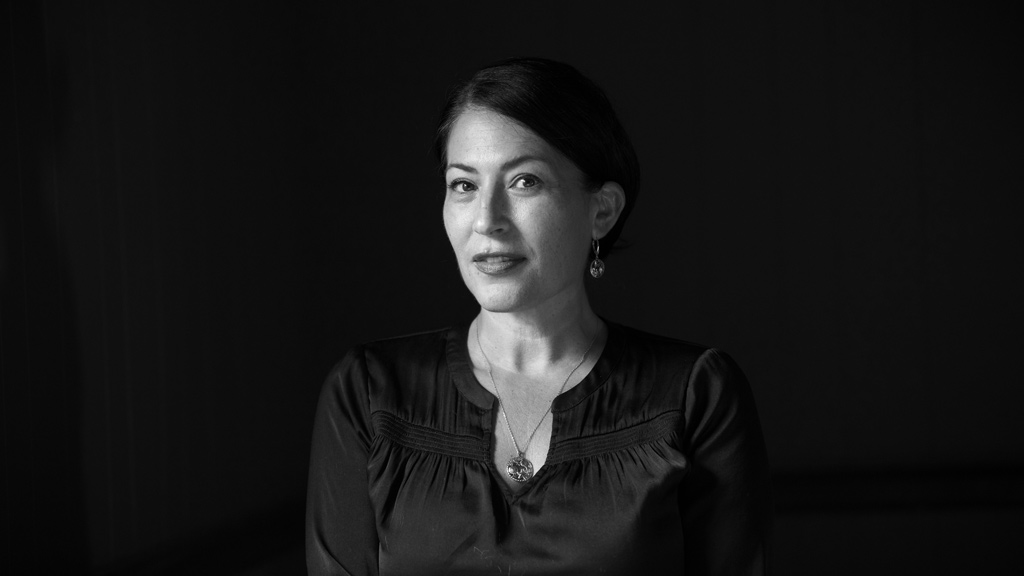 grayscale portrait of a woman on a black background