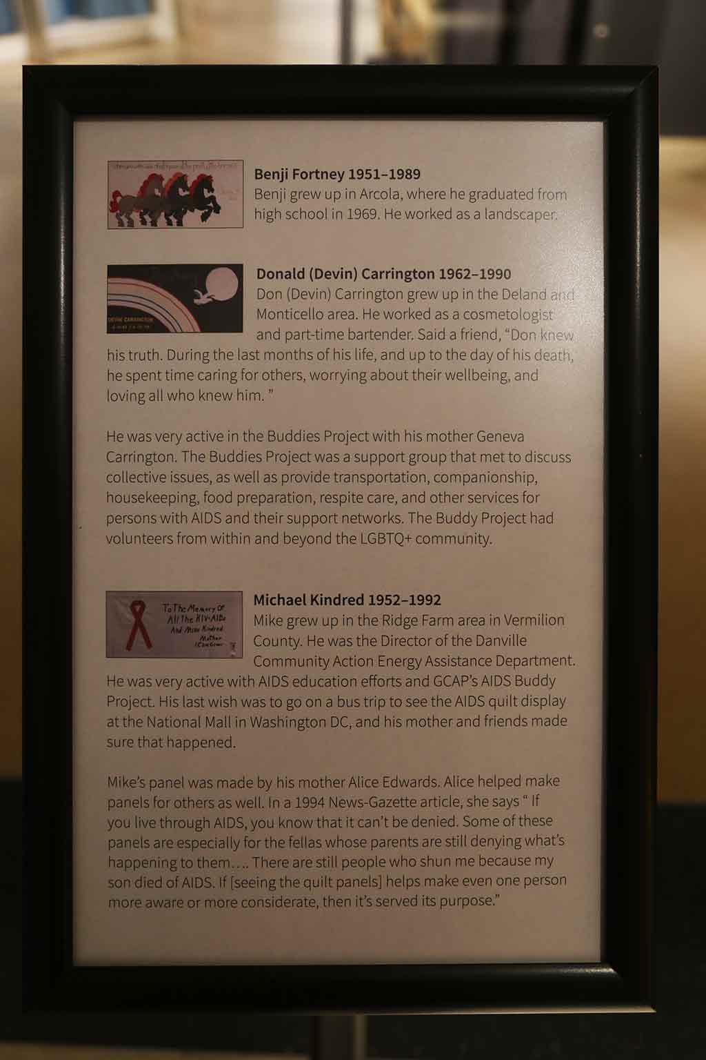 A plaque with images of quilt panels and corresponding information