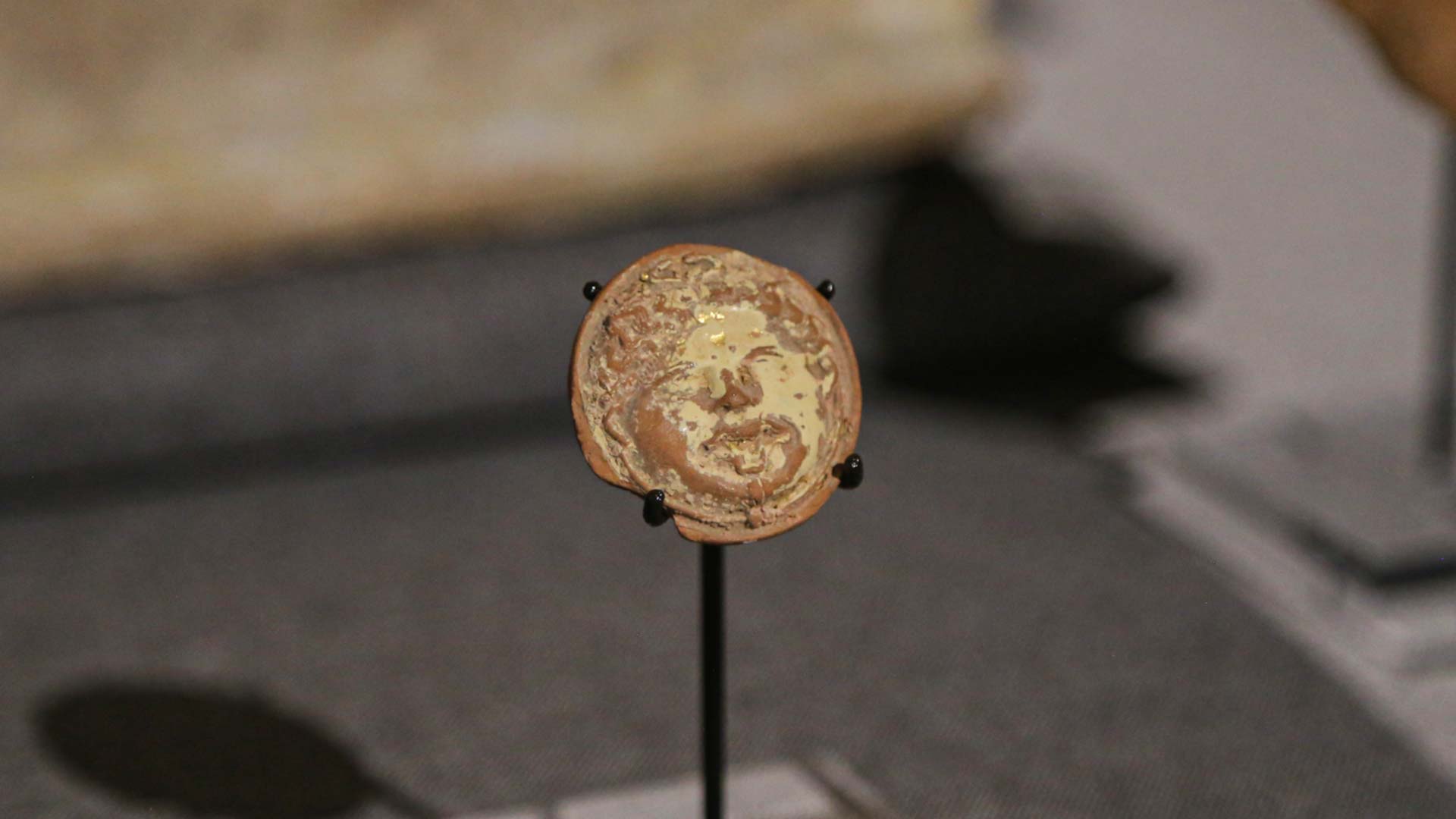 Face of a gorgon made with terracotta