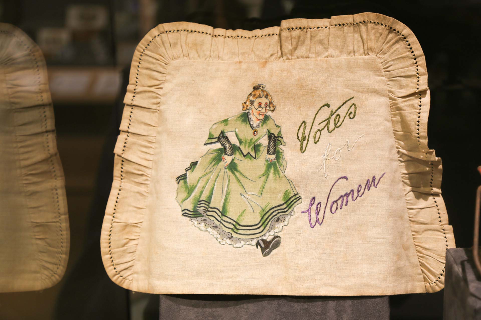 Purse with the phrase 'Votes for Women' sticked on top
