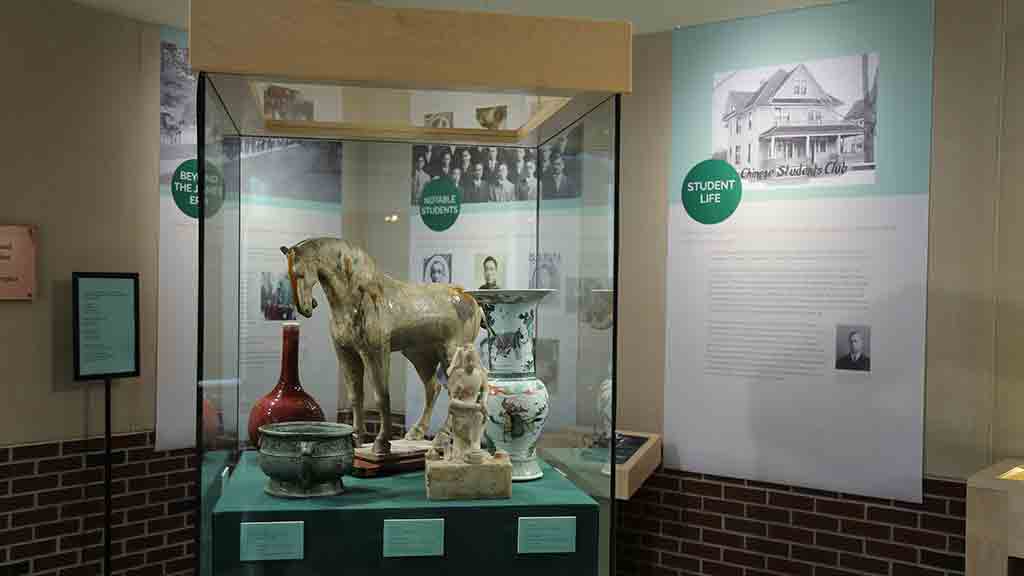 display case with china potteries, sculptures of horse and Chinese god, greencopper container
