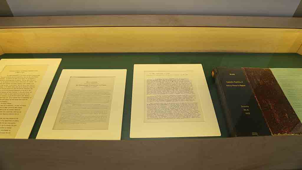 documents and a book with black and dark red cover