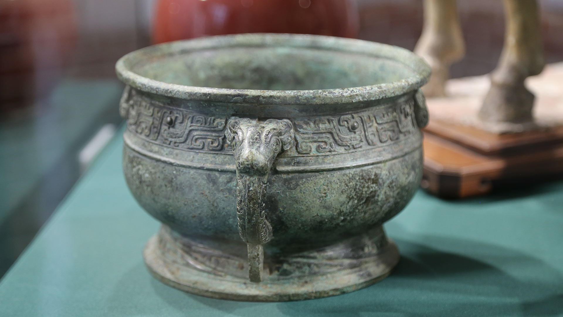 greencopper container with sculpted patterns
