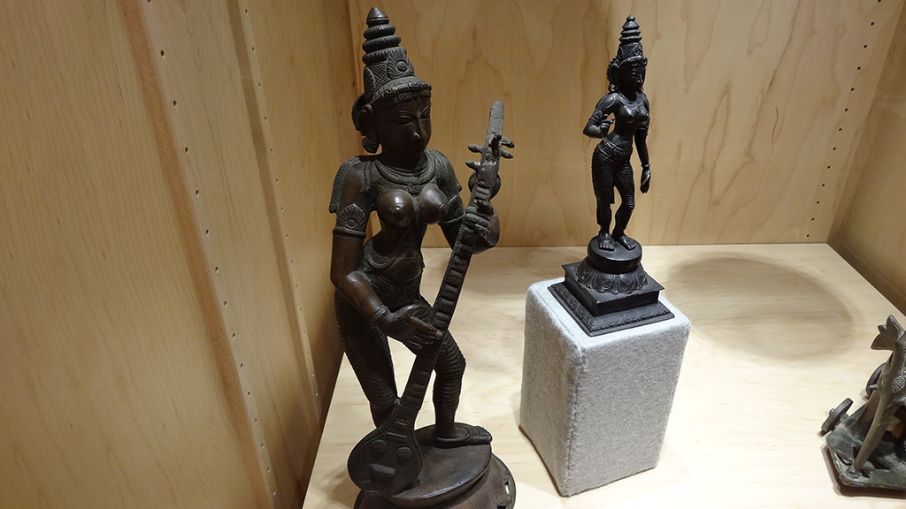 sculpture of a woman holding an instrument