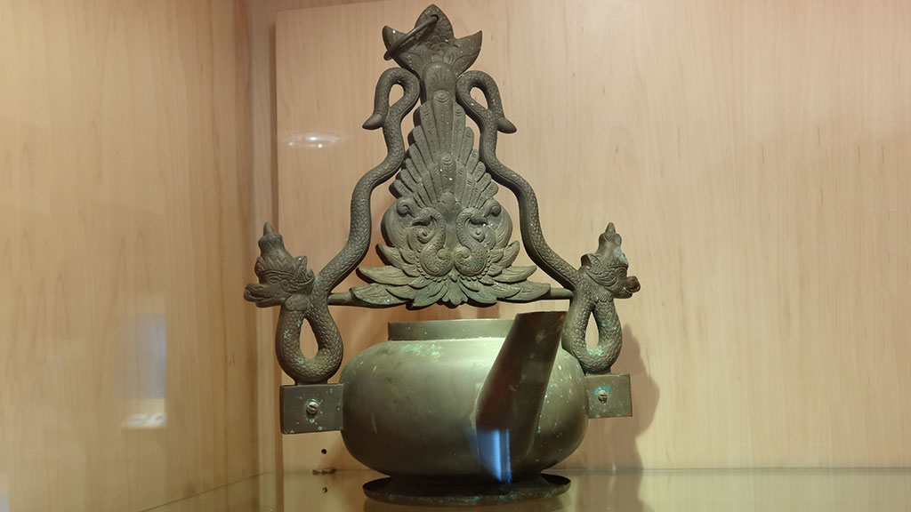 greenish kettle with intricate design