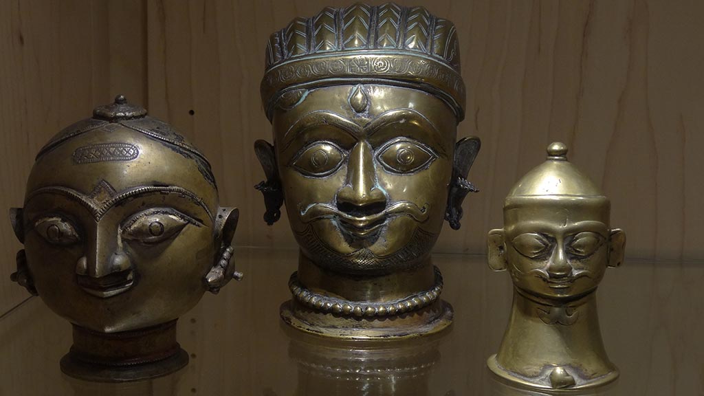 three portrait sculptures of people