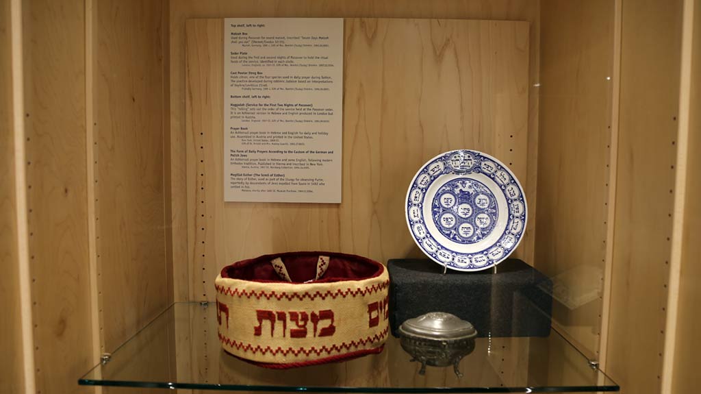 a plate with blue prints, a metal container and a basket