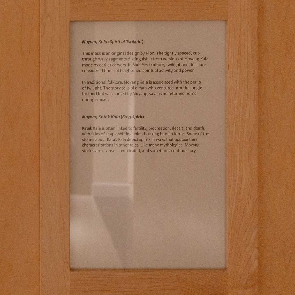 A plaque describing the Spirit of Twilight and Frog spirit woodcarvings