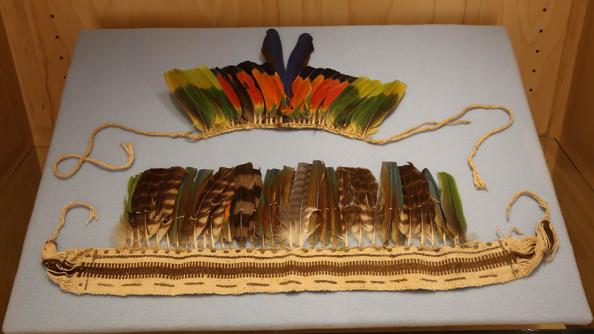 headdress made of woven twine with multicolored feathers attached