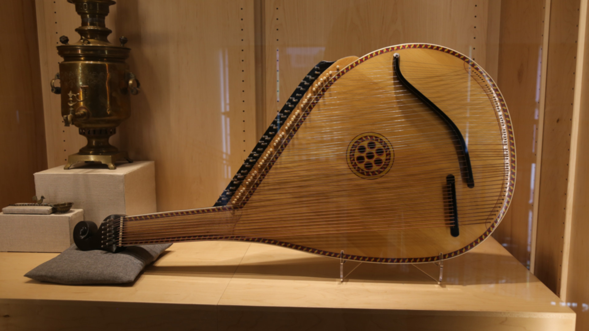 a stringed wooden instrument with a small neck and large, round body