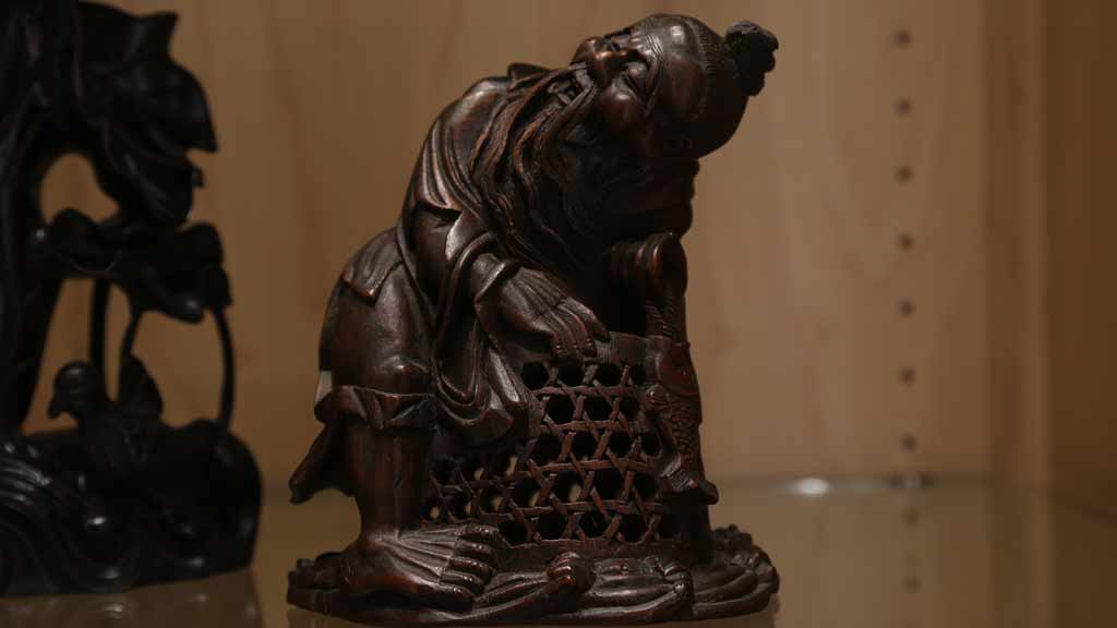 close-up of a man holding a basket at work