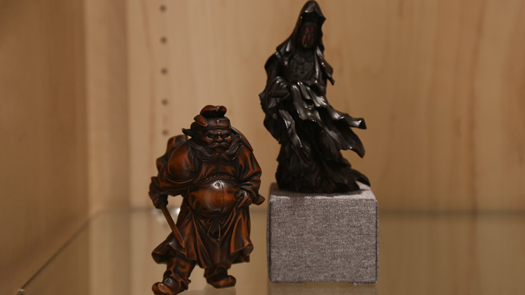two figures that appear to be standing on guard. one is brown and the other is black