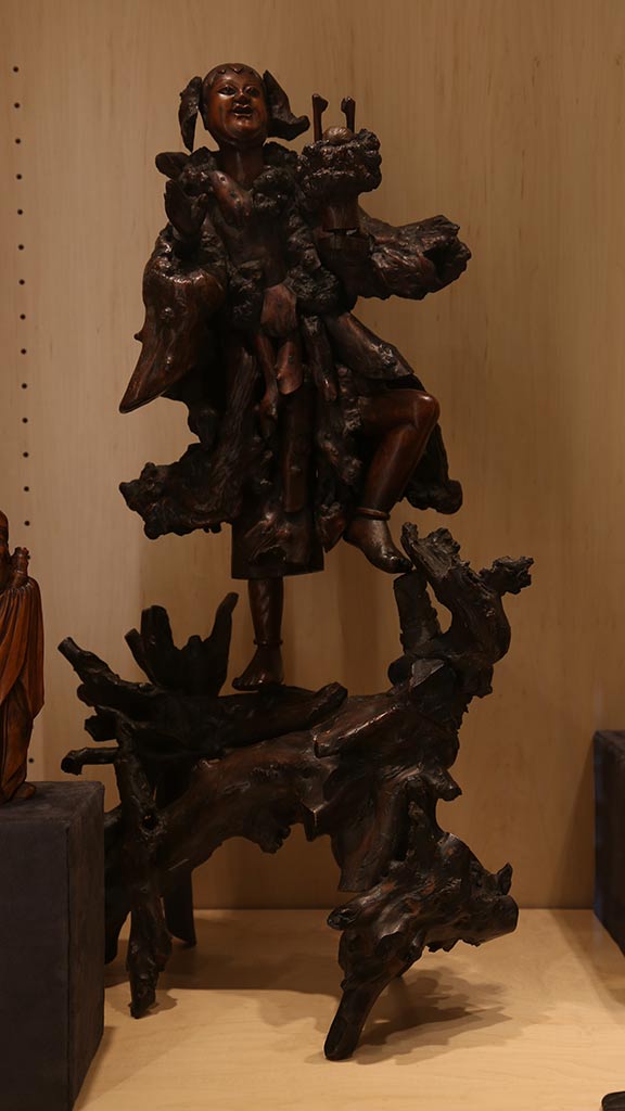 alternate view of the person standing on branches with someone holding on to them