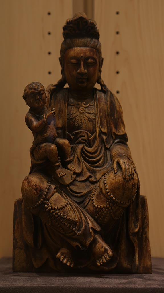 close-up of a sitting person holding a baby