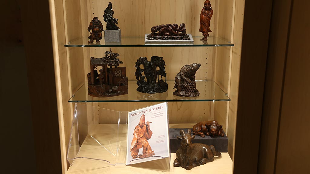 shot of all the objects in a case that contains the 'sculpted stories' book