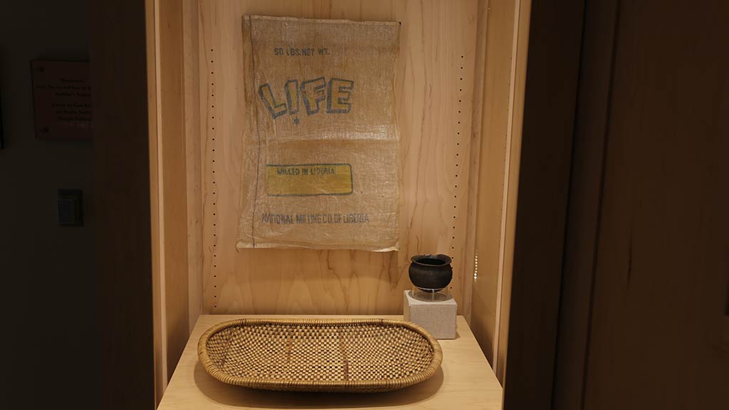 woven tray, a small black pot and a thin sheet with text Life on it