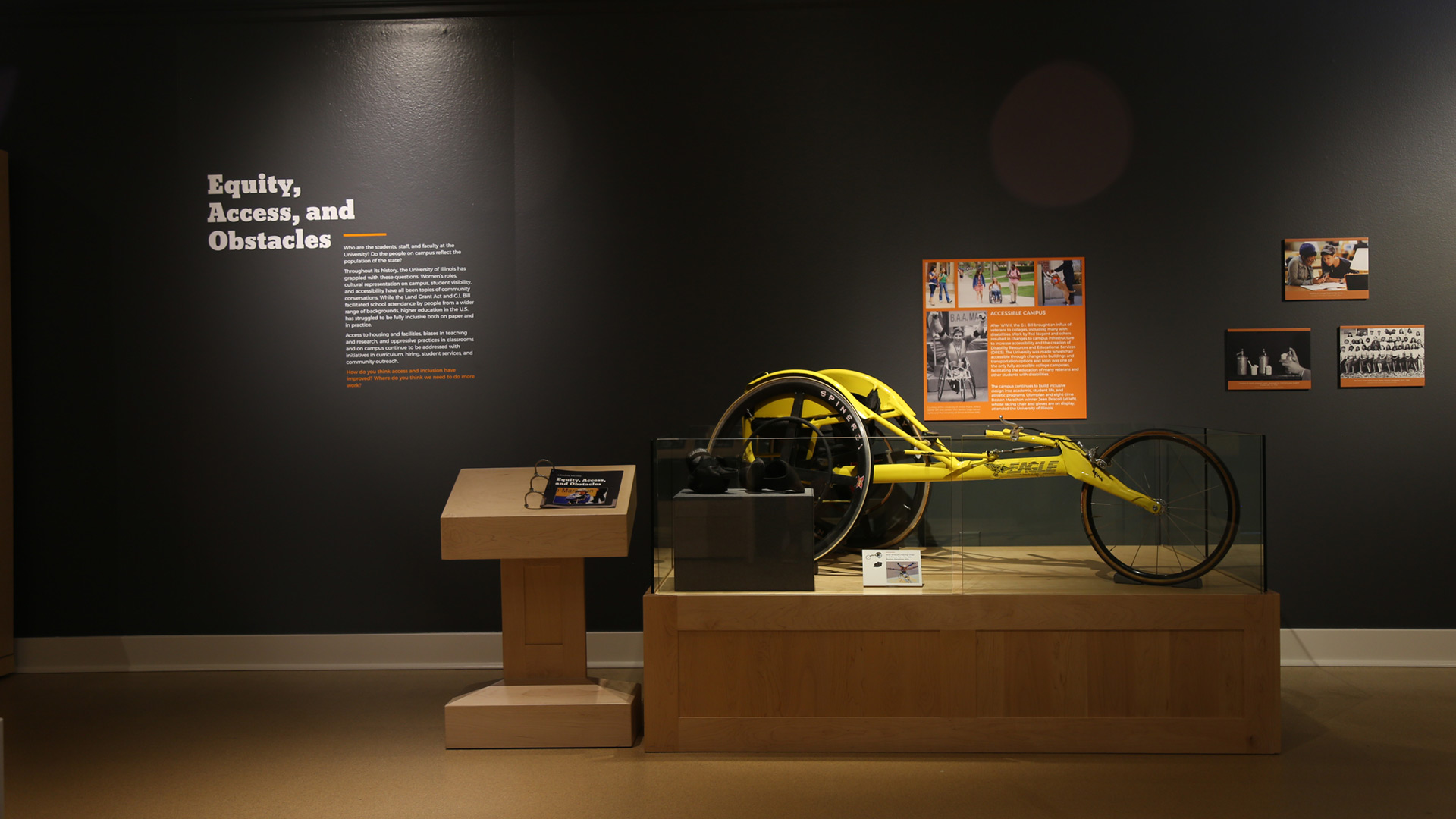 a shot that encompasses the bike in front of a wall with heading text and pictures