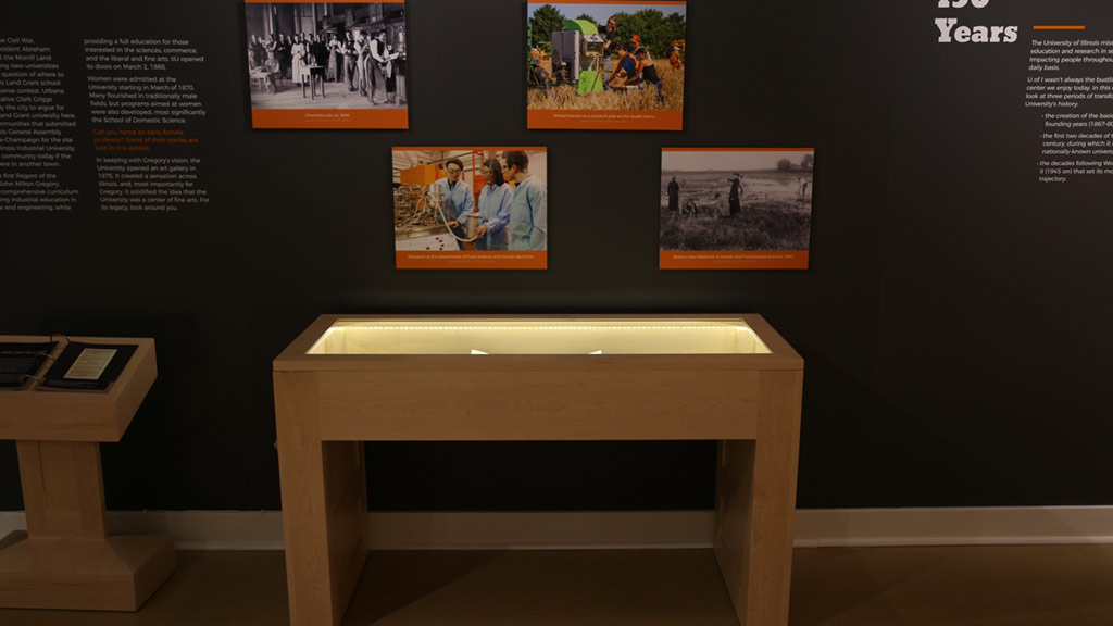 pictures on a wall with a display case under