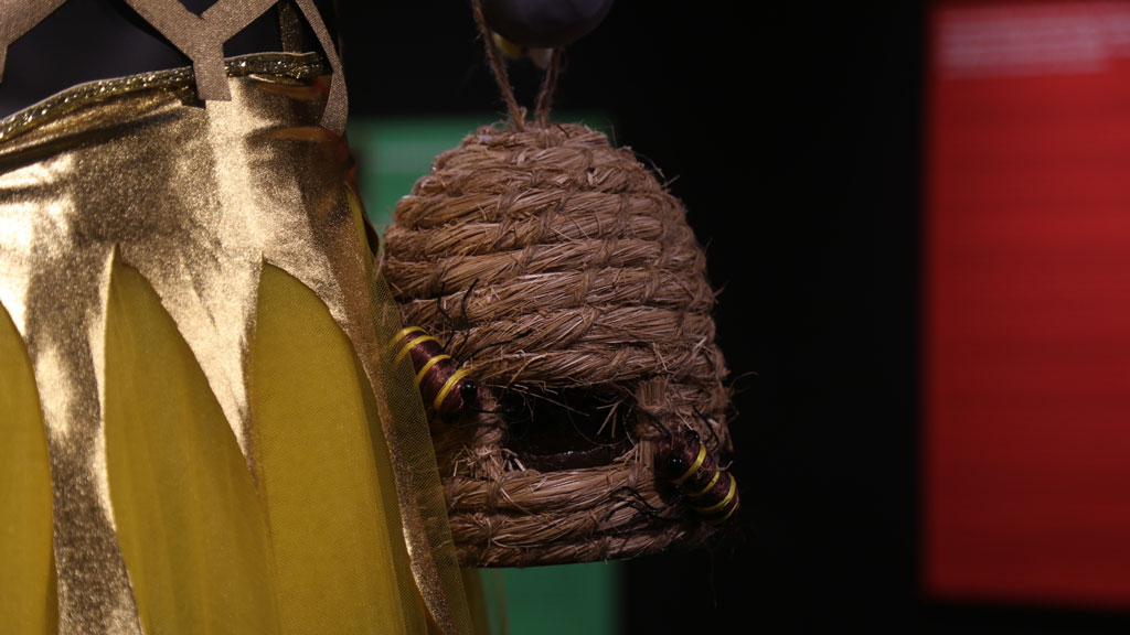 closeup of bag that resembles a bees' nest with bees attached