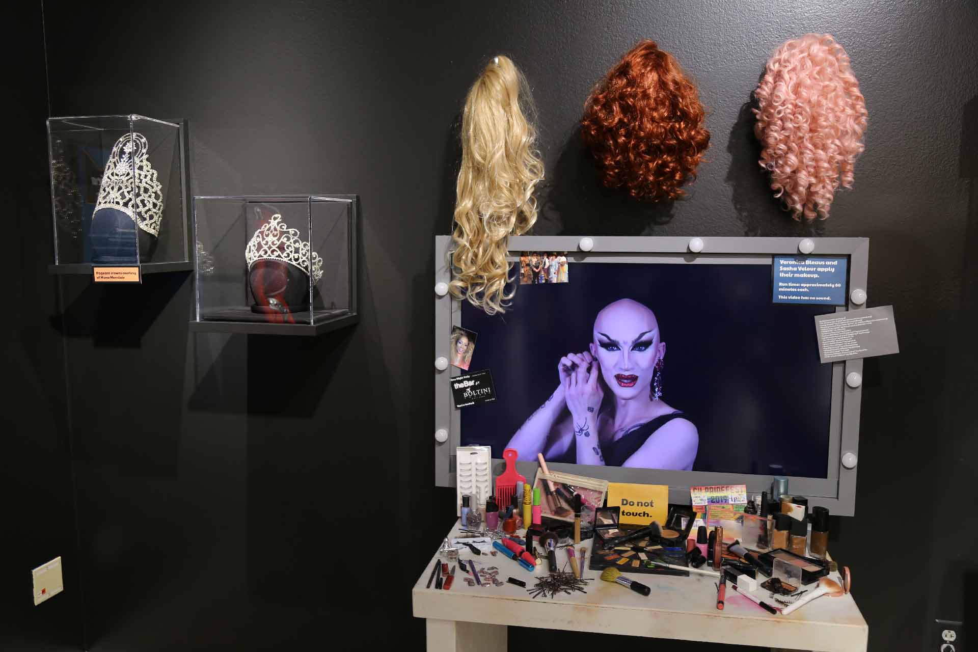 TV Screen showing a person doing makeup on vanity table