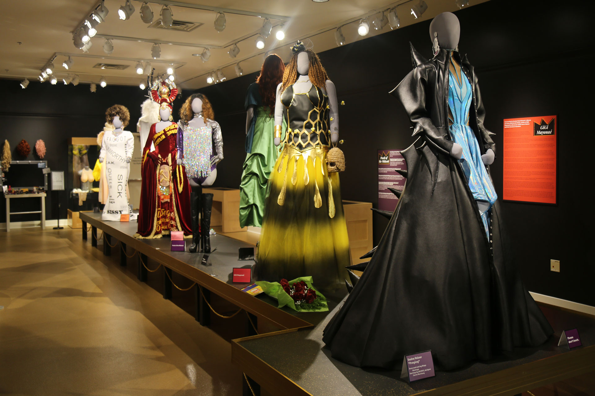 view of runway with several mannequins in elaborate costumes