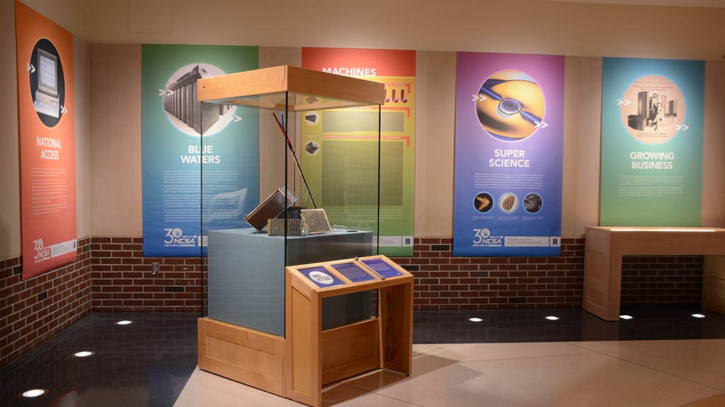rectangular objects in a display stand, large colorful posters on the wall