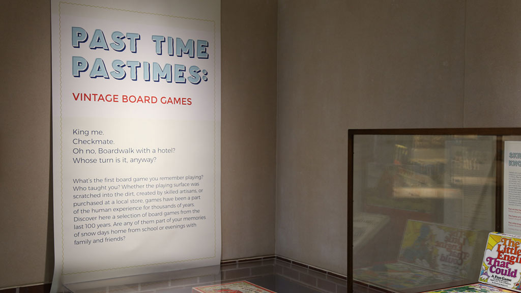 text card with the title of the exhibit 'past time pastimes: vintage board games' on it