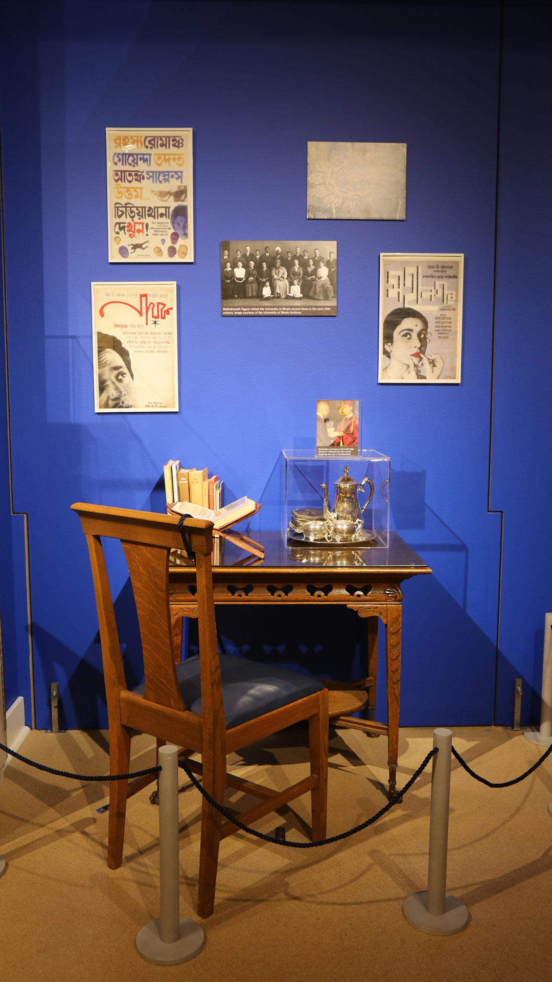 photo of a tea set in a box on a table with various pictures on the wall
