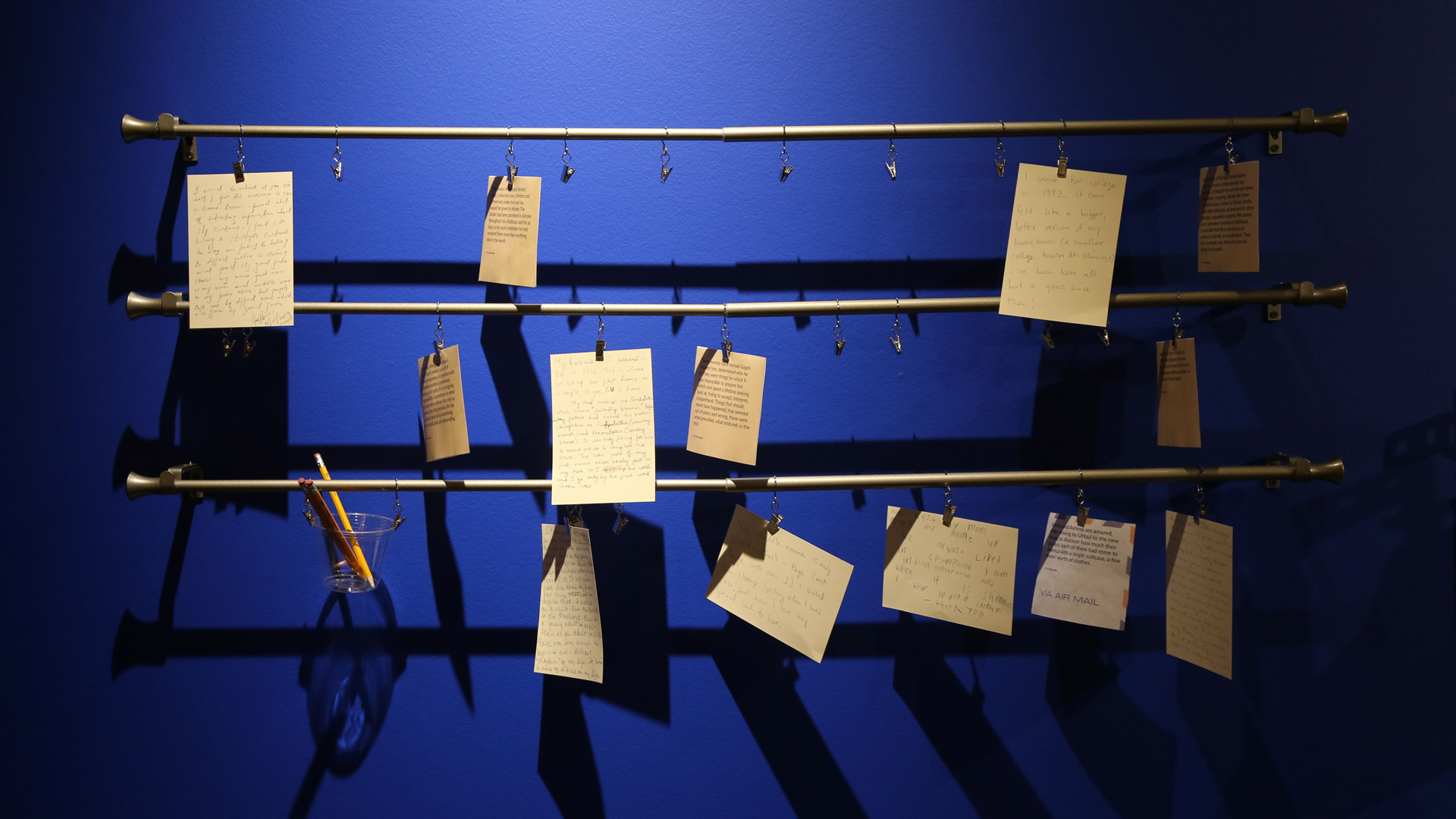 several hanging pieces of paper with writing on them
