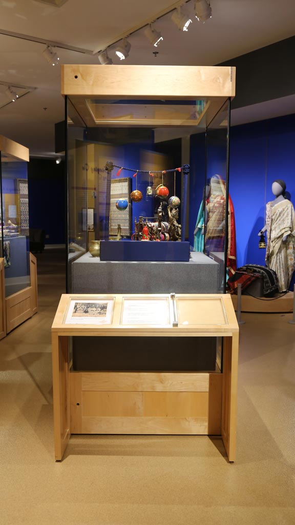 display case with some sculptures and hanging decorative balls