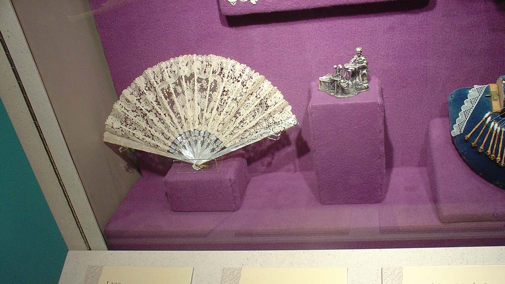 white fan with intricate hollow out pattern