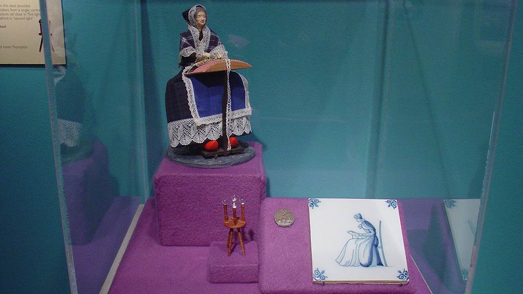 doll woman doning needlework