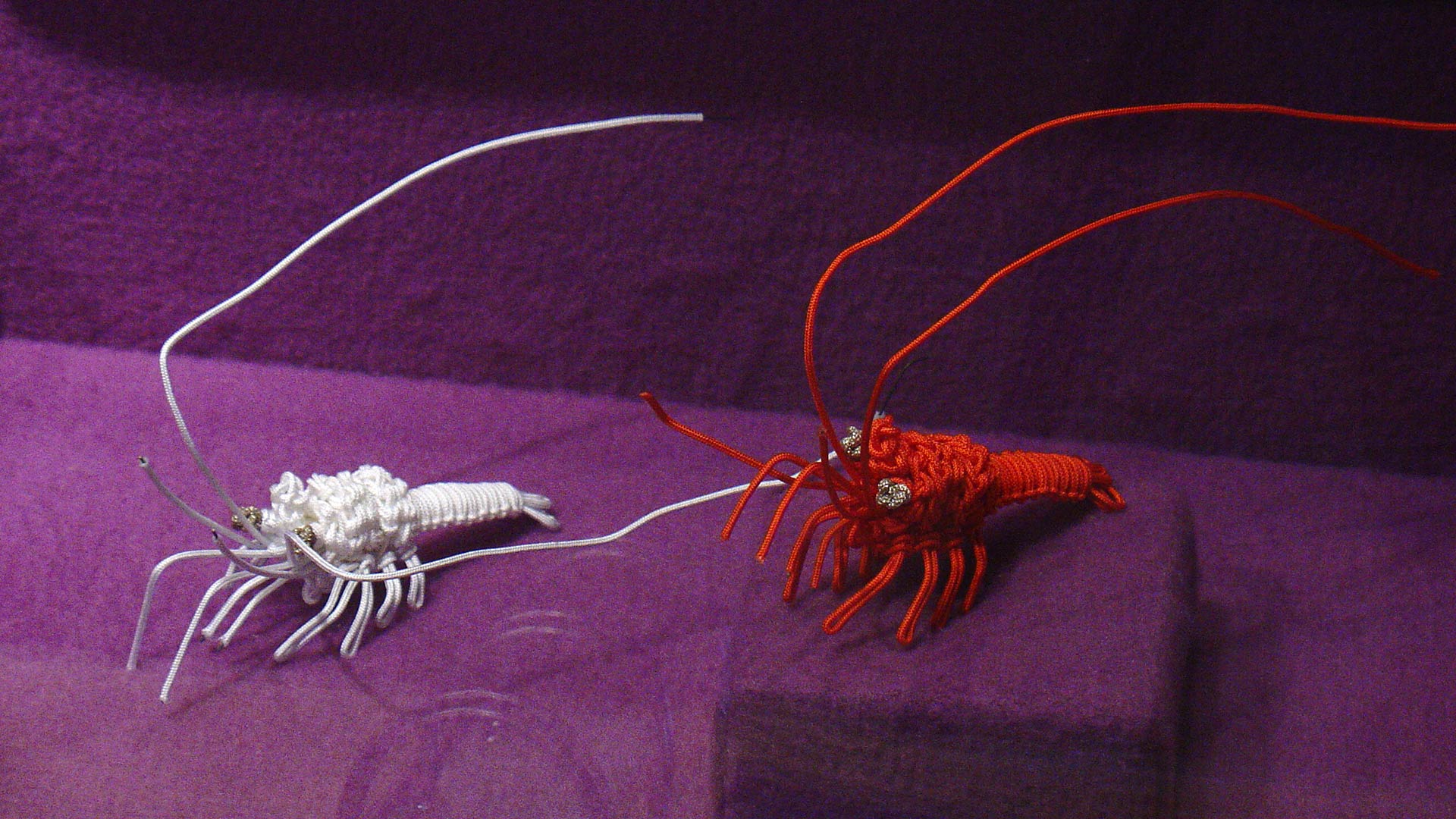 woven losbters, one red and one white