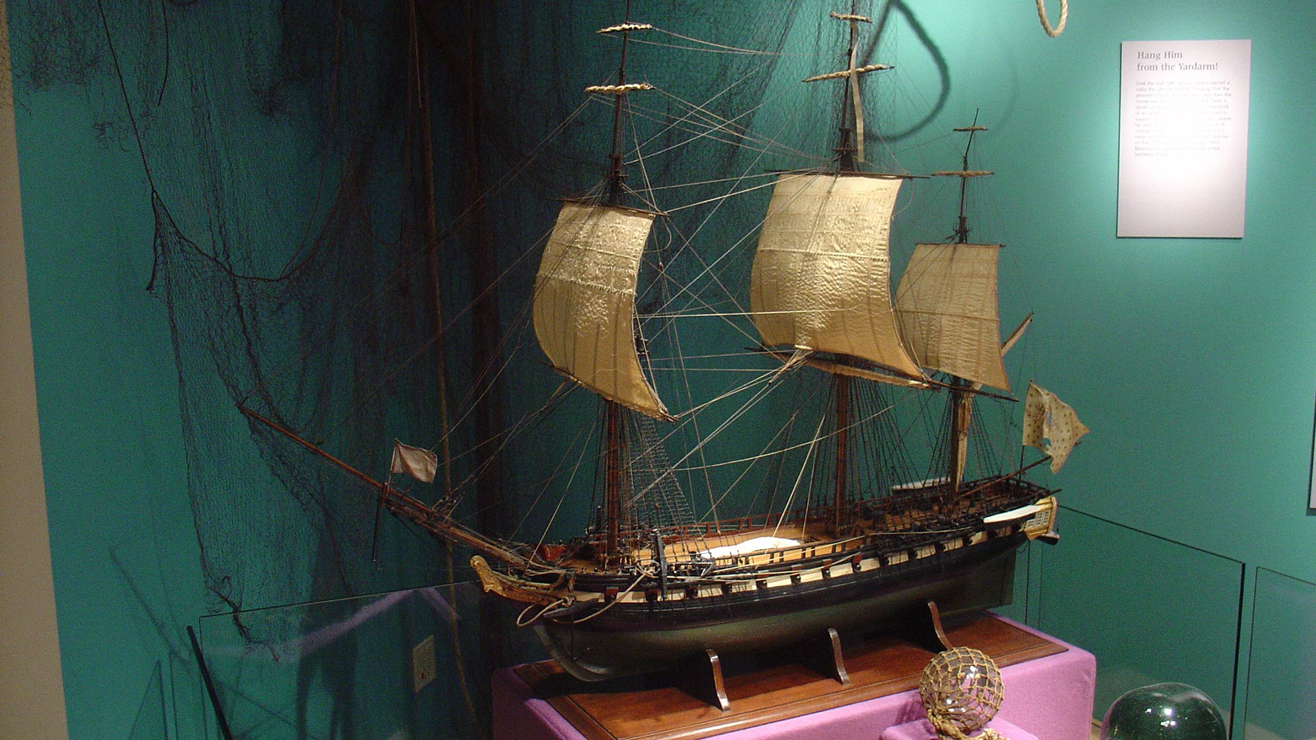 model of a sailling boat, bluish green backdrop